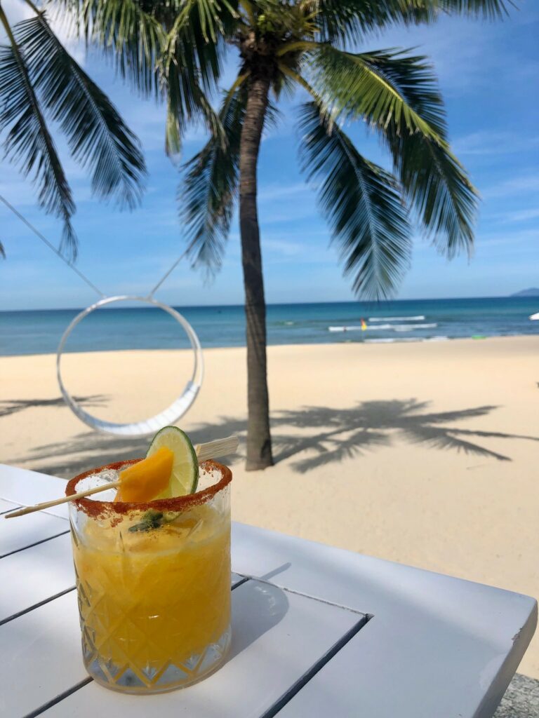 Mango cocktail by the beach under coconut tree in Hyatt Danang, Vietnam by Don't tell my sisters