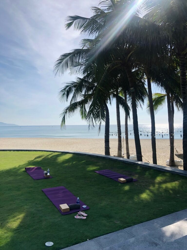 Yoga class under palm tree in Hyatt Danang, Vietnam