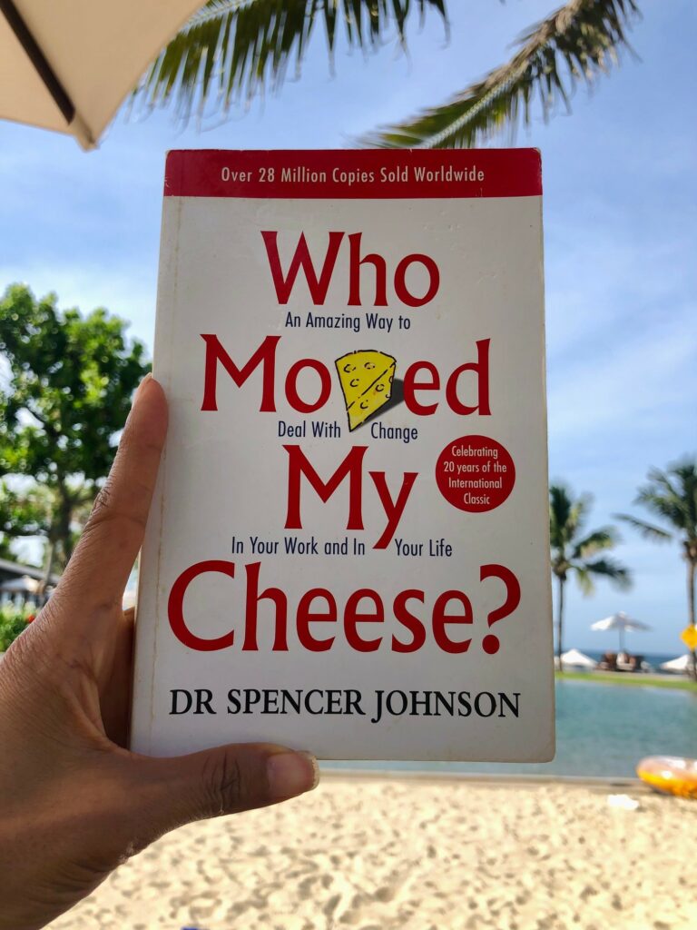 Picture of th book Who moved ly cheese? in front of a swimming pool at Hyatt Danang